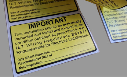 Yellow Periodic Test Inspection warning labels on a surface