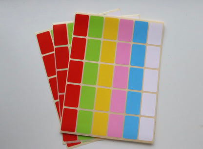 Sheets of small rectangular color-coded labels in red, green, yellow, pink, blue, and white.