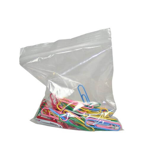 Clear plastic bag filled with colorful paper clips on a white background