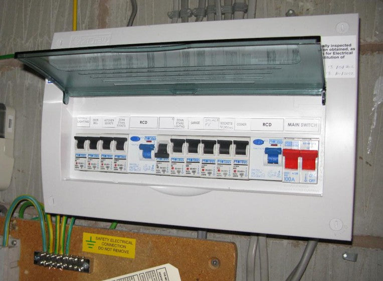 A white electrical consumer unit with an open tinted lid showing black, blue, and red switches.