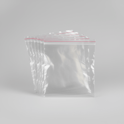 Set of clear resealable grip seal poly bags made from transparent plastic for storage and packaging.